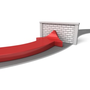 An arrow traveling down a road hits a brick wall road block in this concept of an obstruction to progress.