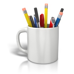 An image of a coffee cup being used as a holder for pencils and pens.