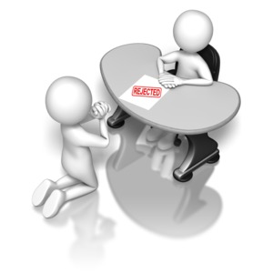 A person on his knees begs to his boss sitting behind a desk with a paper stamped &#039;REJECTED&#039;.