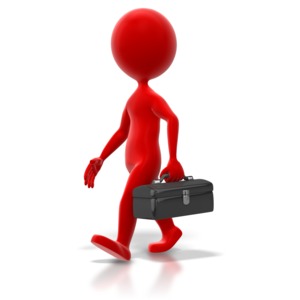 A stick figure colored walks with a black toolbox.