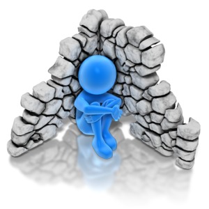 An stick figures huddles alone in the corner of a demolished wall.