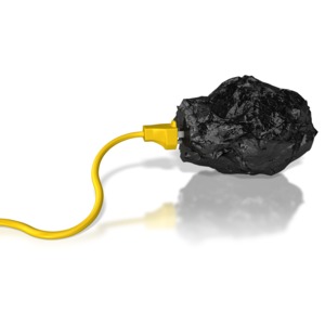 A power cord plugged into a chunk of coal.