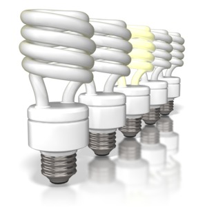 This clipart image shows a row of five cfl light bulbs with the third one lite up.