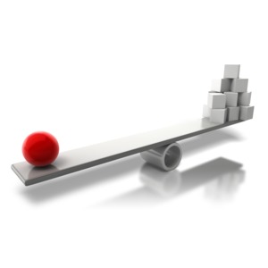 An image of a colored ball balancing out a bunch of boxes on a teeter totter.