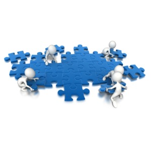 An image containing a group of people putting the puzzle pieces together.