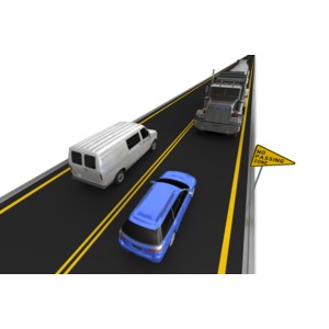 A car passes in a no passing zone as a semi is in the oncoming lane.  Left side driving.