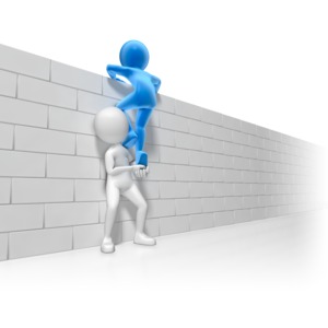 A stick figure helps another climb over a brick wall. This clip-art can represent using teamwork to overcome and obstacle.
