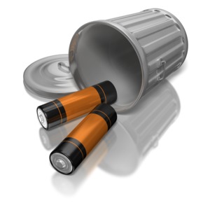 Two batteries spill from a tipped over garbage can. This clip-art can represent electronic waste.