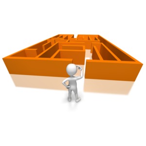 This clip art image shows a stick figure with a puzzled gesture looking on a the opening of a maze.