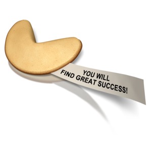 A paper message of success comes from inside a fortune cookie.