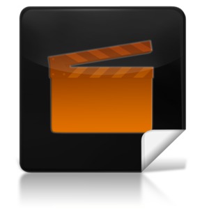 This clip art image shows a black icon with a movie clapboard on it.