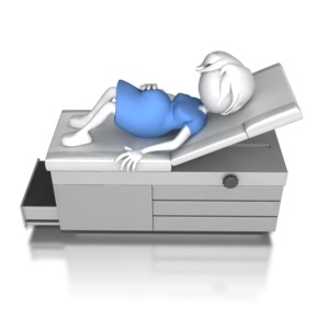 A woman is waiting on a doctors exam table.