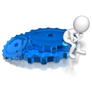 A stick figure sits and thinks on a pile of gears. This clip-art can represent thinking-up a new process.