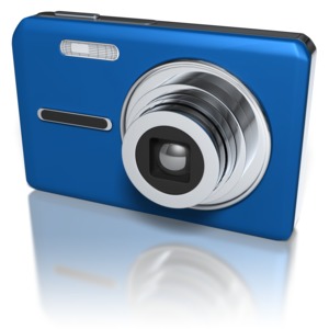 A compact digital camera with it&#039;s lens open.