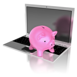A pink piggy bank sits on a notebook computer. This clip-art can represent online banking.