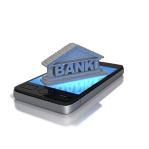 A picture of a bank on top of a phone showing mobile banking.