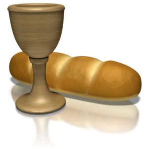 A clay chalice next to a loaf of baked bread.