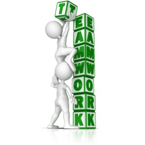 Two stick figures work together to stack blocks that spell teamwork.