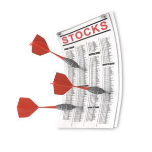 Three darts are stuck into a newspaper stocks page.