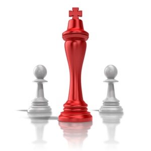 A single king chess pieced flanked by two pawns.  A concept of leadership or strategy.