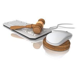 A court gavel lays on a computer keyboard.