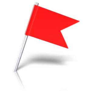 An image of an angled flag pinned into the ground.