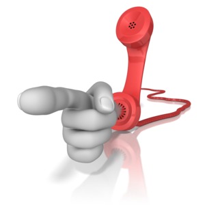 A large hand comes out of the end of a phones receiver and points in an accusing gesture. 