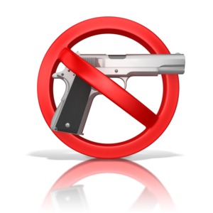 This clip art image shows a gun inside a prohibited symbol.