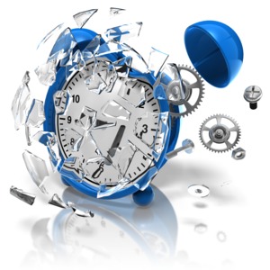 An alarm clock breaks apart into many pieces.