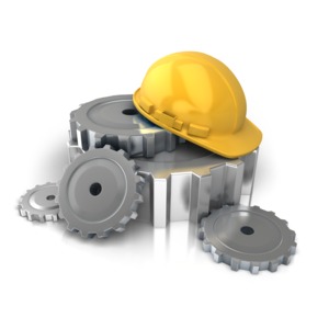An image of a set of gears with a construction helmet on top.