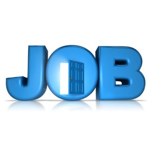 A door in the O of job has a door open and light coming out.