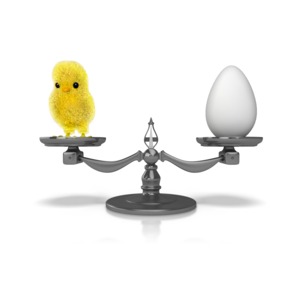 This clip art shows both an chicken and an egg on a weight scale.  Displays the question what came first the chicken or the egg.