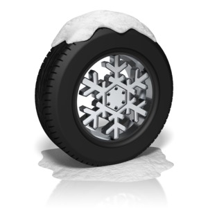 A wheel with a snowflake rim covered in snow.