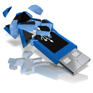 A USB drive shatters into many pieces.