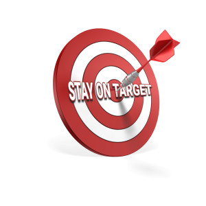 A dart in the bullseye of a dartboard.  You can replace the text on the board with your own.