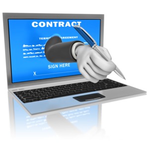 A hand holding a pen reaches out from a notebook computer to sign a contract.