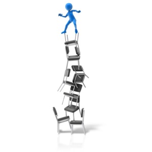 An image of a stick figure balancing on top of a pile of stacked chairs.