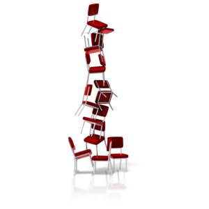 An image of a group of chairs stacked balancing on one another.