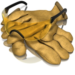 A pair of safety glasses rest on top of some work gloves.