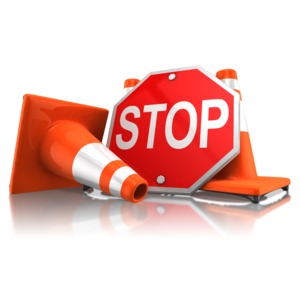This clipart shows a stop sign leaning against traffic cones.
