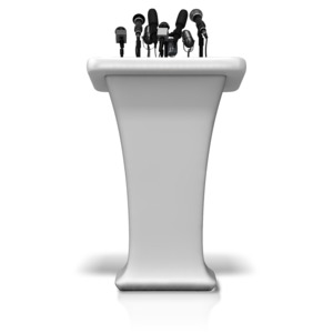 An image of a podium with many microphones.