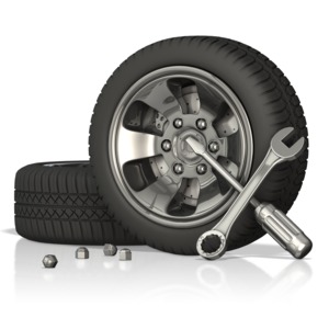 This clip art image shows an automobile tires with tools next to them.