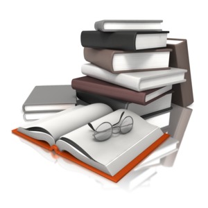 An image of a stack of books with glasses on top of an open book.