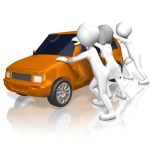 Three rioters rock a car back-and-forth.