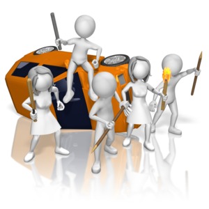 A group of armed rioters protest around a tipped-over car.