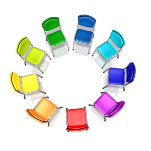 Multiple colored chairs in a circle showing diversity in a group.