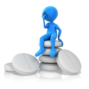 A stick figure is shown sitting on top of white pills