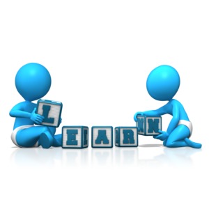 This clip art image shows two baby figures playing with letter blocks that spell learn