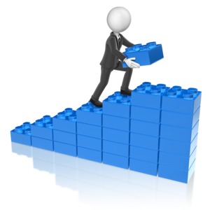 A business man stack another block onto a bar graph. This clip-art can represent someone growing business.