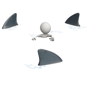 A stick figure is shown swimming in water surrounded by sharks.